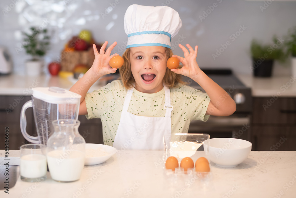 Child chef cook with eggs. Kid chef cook wearing cooker uniform and chef hat preparing food on kitchen. Cooking, culinary and kids food concept. Child chef cook with eggs. Kid chef cook wearing cooker uniform and chef hat preparing food on kitchen. Cooking, culinary and kids food concept.
