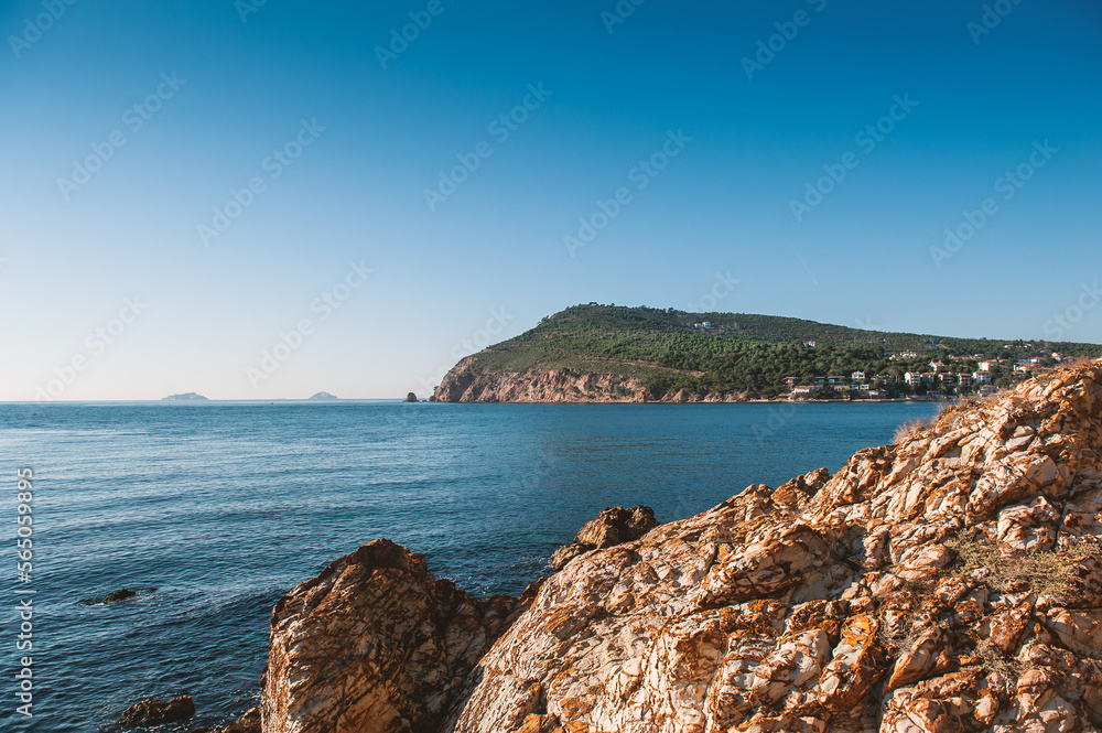 Beautiful sea landscape with island, blue sky, sunlight and blue water