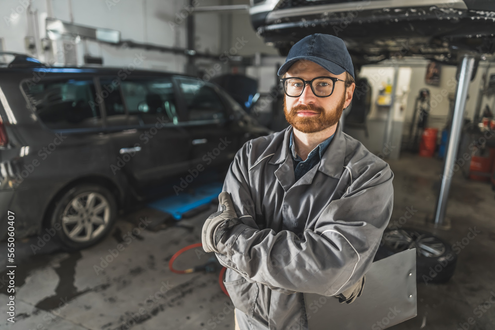 Portrait of a car mechanic with a black clipboard in an automobile repair shop. High quality photo Portrait of a car mechanic with a black clipboard in an automobile repair shop. High quality photo