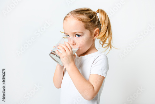 Image of child drinking milk on white background