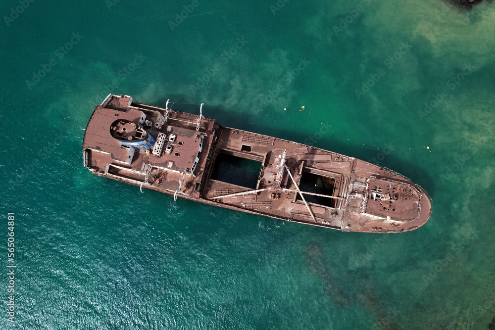Aerial drone point of view from above to the abandoned ship after shipwreck on the shore between Arrecife and Costa Teguise of Lanzarote Island. Spain. Travel destinations concept
