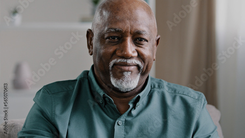Close up African elderly grandfather posing at home. Portrait male business worker indoors in office company CEO old mature senior American man ethnic businessman looking at camera middle-aged boss