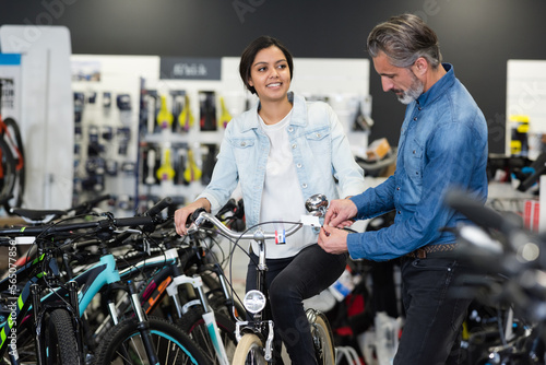 couple in bike shop buying bicycle after buying