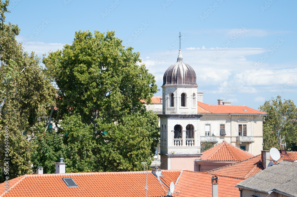 Beautiful bell tower from Church of Our Lady of Health surrounded with old platanus trees in Zadar, Croatia