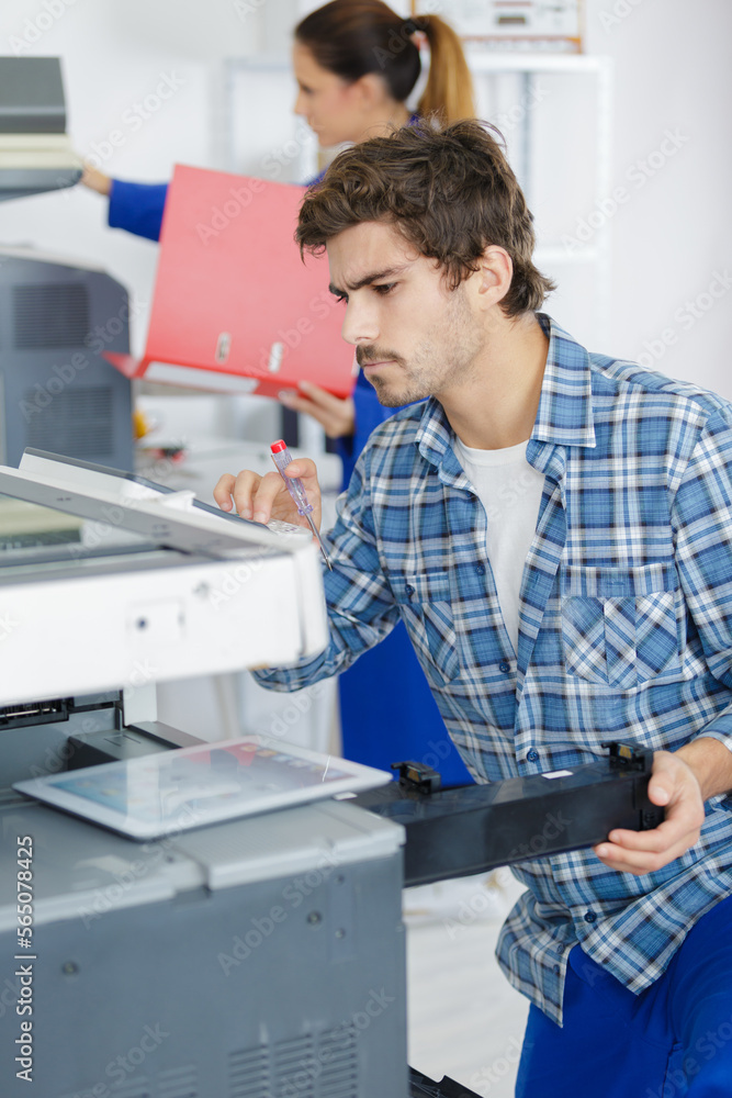 technician man opening photocopy machine in a office technician man opening photocopy machine in a office