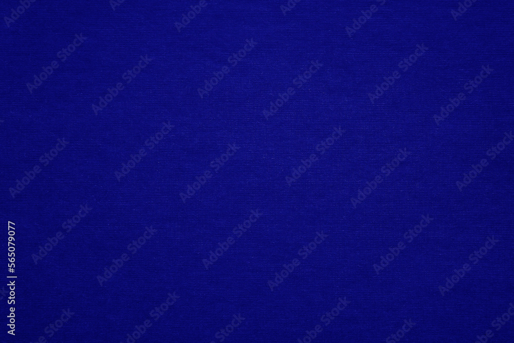 Texture of dark blue fibrous paper, cardboard, close-up. Background, embossed surface. Copy space.	

