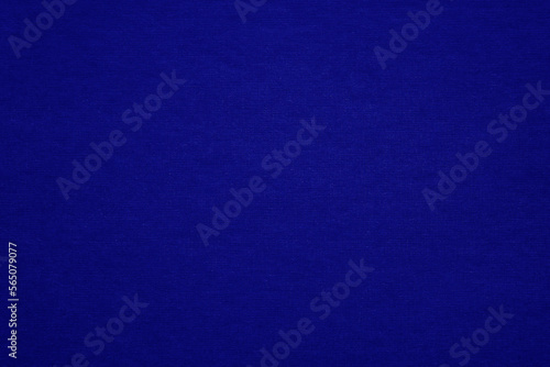 Texture of dark blue fibrous paper, cardboard, close-up. Background, embossed surface. Copy space. 