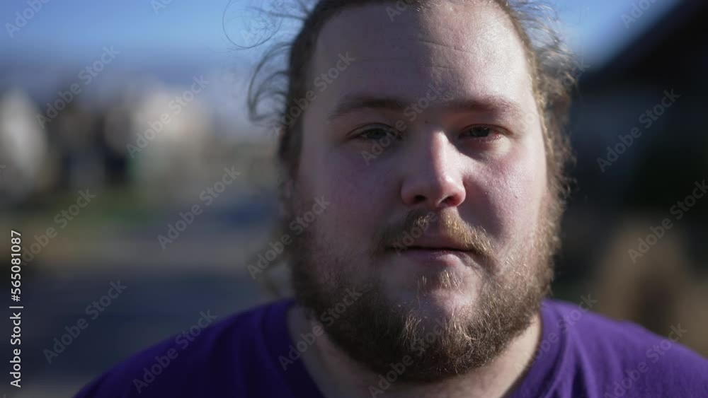 Portrait of a positive chubby young man close up face looking at camera. Casual male caucasian person with beard Portrait of a positive chubby young man close up face looking at camera. Casual male caucasian person with beard