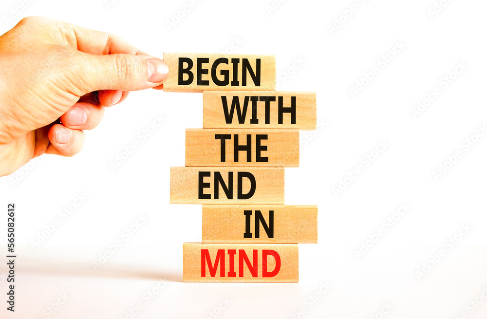 Begin in end of mind symbol. Concept words Begin with the end in mind on wooden blocks. Beautiful white table white background. Businessman hand. Business begin in end of mind concept. Copy space. Begin in end of mind symbol. Concept words Begin with the end in mind on wooden blocks. Beautiful white table white background. Businessman hand. Business begin in end of mind concept. Copy space.