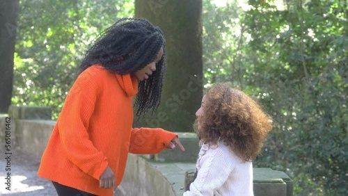 young African girl has an animated discussion with her friend