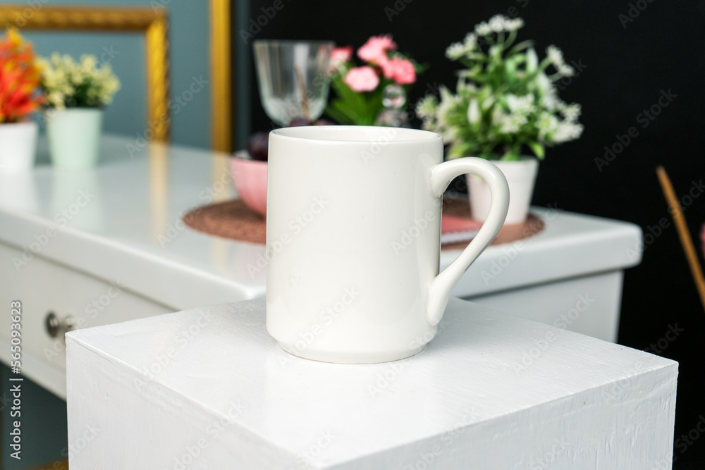 A white blank coffee mug on the top of a hand cloth with simple decorations arranged around it A white blank coffee mug on the top of a hand cloth with simple decorations arranged around it