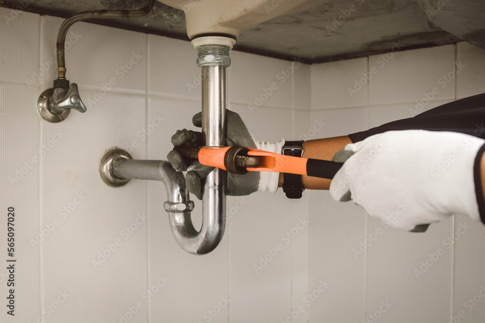 plumber at work in a bathroom, plumbing repair service , fix water plumbing leaks, replace the kitchen sink drain plumber at work in a bathroom, plumbing repair service , fix water plumbing leaks, replace the kitchen sink drain