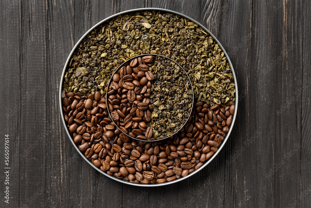 Green tea and coffee grains on a dark wooden background top view close-up. Green tea and coffee grains on a dark wooden background top view close-up.