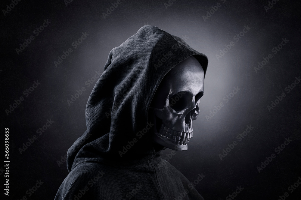 Grim reaper over dark misty background Grim reaper over dark misty background