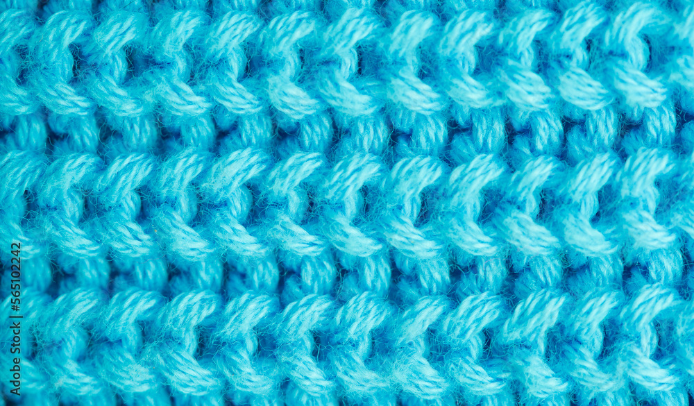 Background of knitted fabric with a pattern. Weaving winter clothes close-up. Background of knitted fabric with a pattern. Weaving winter clothes close-up.