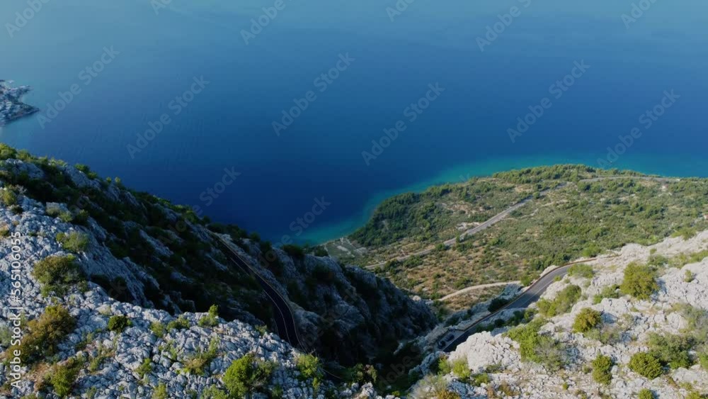 Cinematic aerial shot of road on the cliff. Mountains near sea Cinematic aerial shot of road on the cliff. Mountains near sea