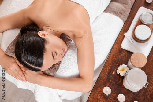 Young woman resting after professional massage in spa salon, above view