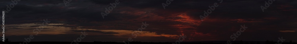 Purple-magenta clouds. Tragic gloomy sky. Landscape with bloody sunset. Fantastic skies on the planet earth. Twilight, nightfall. Blackout.