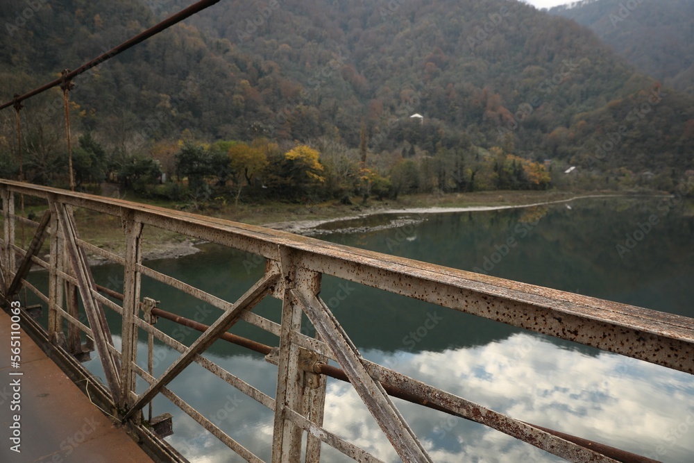 Picturesque view of metal bridge over river in mountains