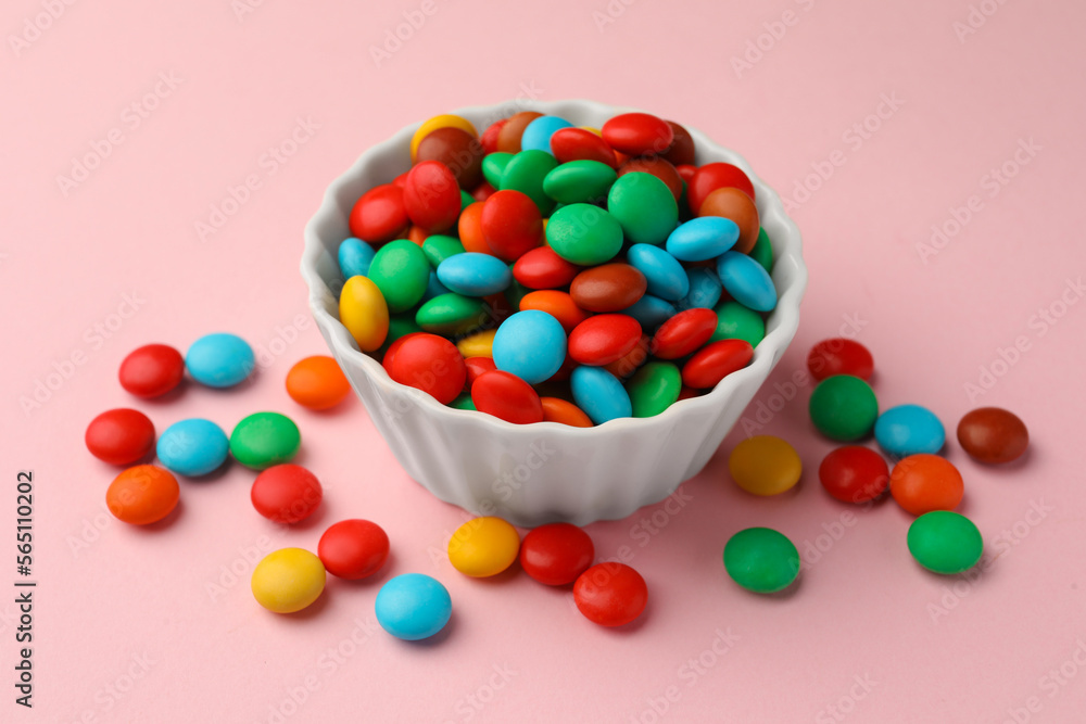 Tasty colorful candies on pink background, closeup