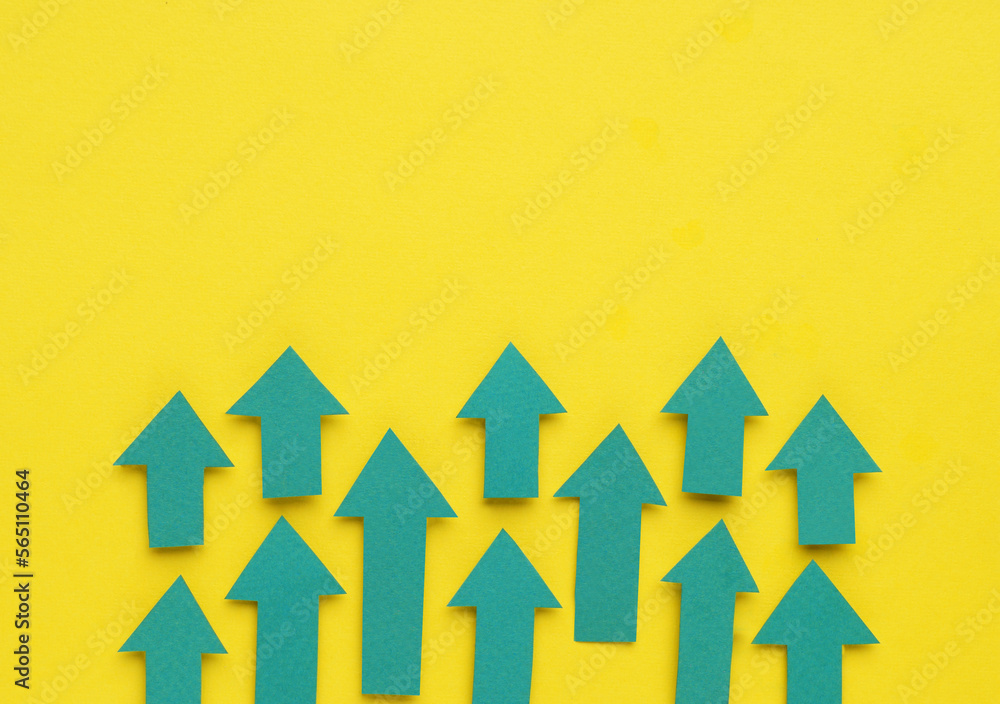 Paper arrows on yellow background, flat lay. Space for text Paper arrows on yellow background, flat lay. Space for text