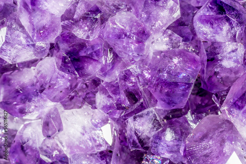 Amethyst purple crystals. Gems. Mineral crystals in the natural environment. Texture of precious and semiprecious stones. Seamless background with copy space colored shiny surface of precious stones.