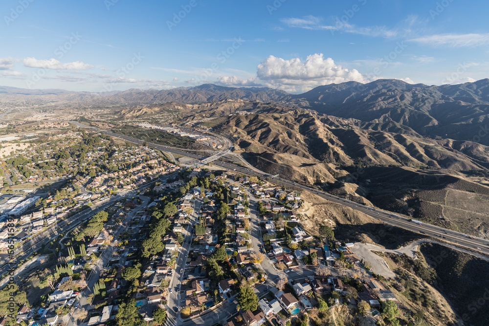 Aerial cityscape view of suburban sprawl in the Santa Clarita community of Los Angeles County, California. - obrazy, fototapety, plakaty 