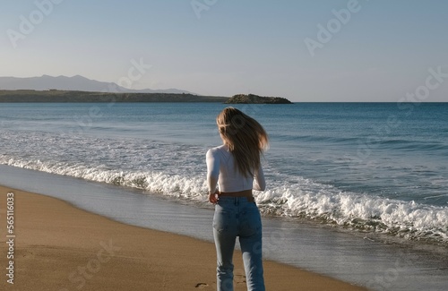 Young woman running along the beach of the sea or ocean and enjoy holiday at coast with on sunset. Amazing beautiful sunset at paradise beach in travel on the seashore. Running on a sandy beach