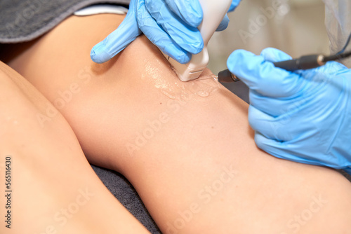 Close-up of percutaneous electrolysis treatment with an ultrasound machine on the leg. Health and medicine concept