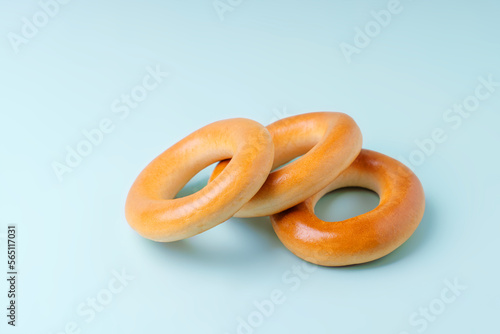 Three yellow calachas bagel lie on a blue background.