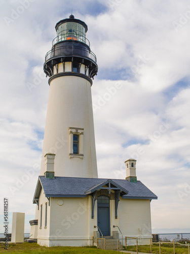 Lighthouse against a blue cloudy sky. Navigation  ship safety  beautiful architecture  environmental protection. Travel destinations advertisement  postcard  banner.