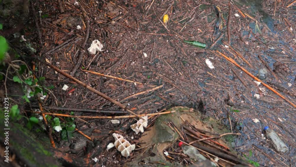 Top-down view of the water polluted with garbage. Background of waves on the surface of water covered with debris after monsoon rains. High quality 4k footage Top-down view of the water polluted with garbage. Background of waves on the surface of water covered with debris after monsoon rains. High quality 4k footage