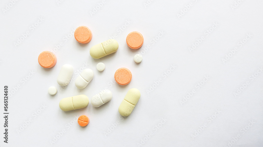 Assorted scattered pharmaceutical medicine pills and tablets in various colour and size isolated in white background, copy space for text or advertising Assorted scattered pharmaceutical medicine pills and tablets in various colour and size isolated in white background, copy space for text or advertising