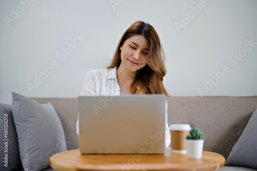 Happy asian woman using laptop and credit card for online payment, E-commerce