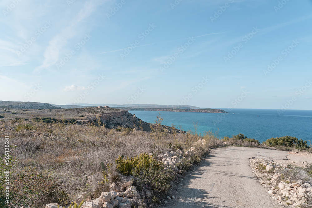 Desolate farmroad leading to the mediterranean sea in Malta