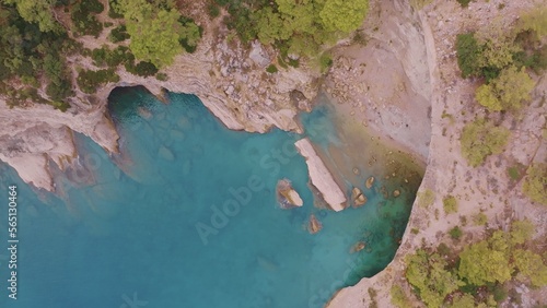 Beautiful seascape. Green trees on the coastline. Rocky coast. Blue water. View from above
