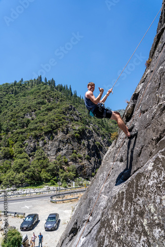 Amateur rock climber attempts to scale wall at Grizzly Creek Bridge located in Plumas National Forest, California 