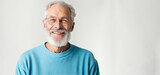Mature, bearded man with a cheerful smile wearing a sweatshirt stands alone on a white background, looking at the camera mid-aged, gray-haired senior hipster