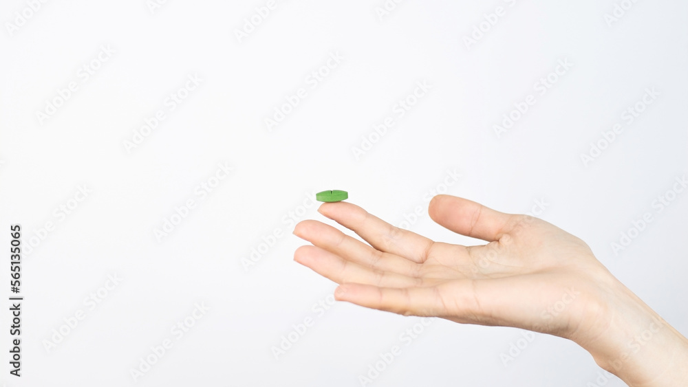 Green capsule lies on the finger isolated on white background Medical Pharmacy Treatment Health Green capsule lies on the finger isolated on white background Medical Pharmacy Treatment Health