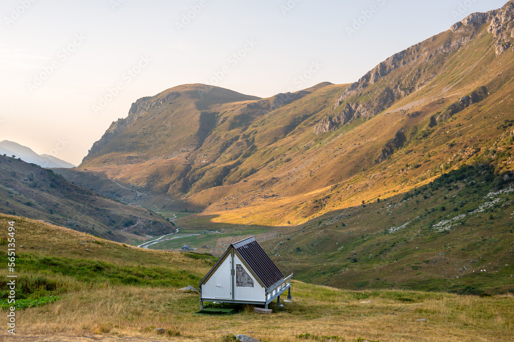Quiet place in the mountains with a small wooden bungalow house in a campsite for peaceful and relaxing vacations in the summer. Alps, mountains background. Quiet lifestyle. Piedmont, Mondovì, Italy