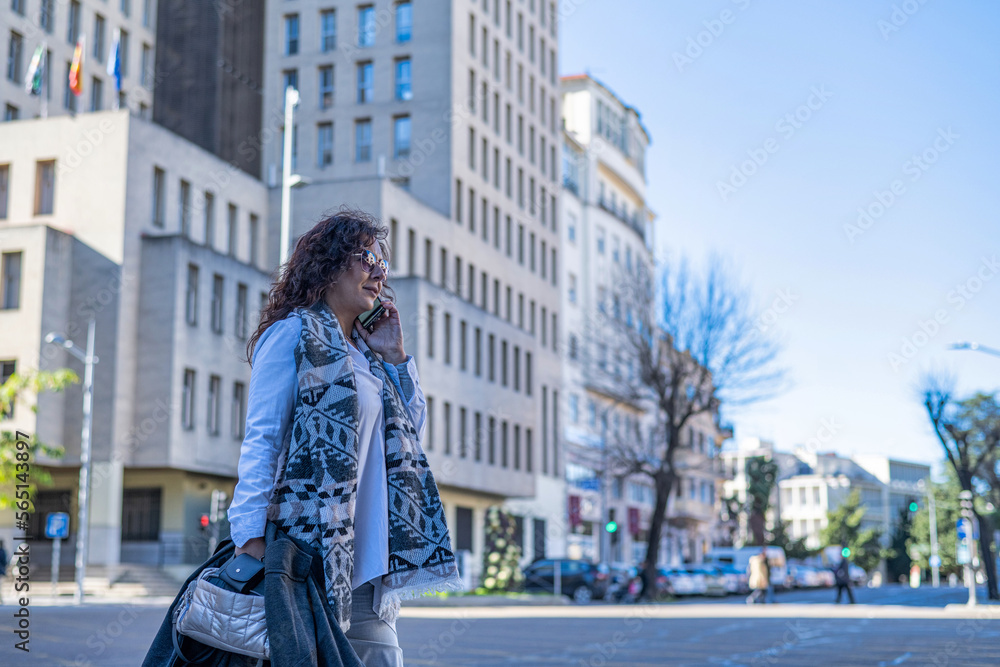 Fototapeta premium Smiling Elegant Woman Using Smartphone In Financial Area.