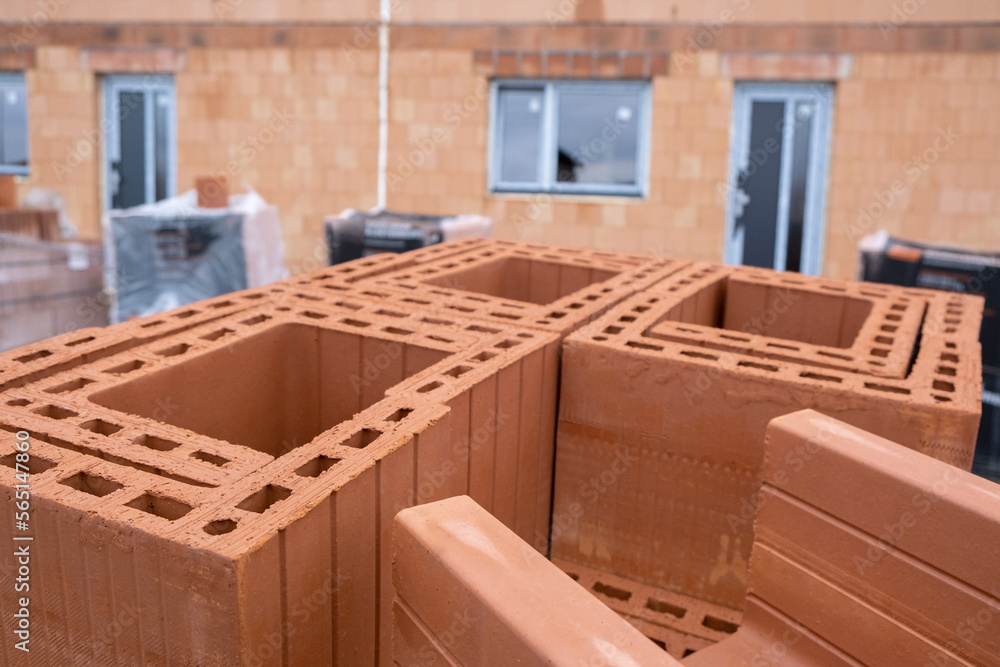 Stack of Red clay Ceramic Thermo Bricks construction material, Work Modular Euro Wall on construction site
