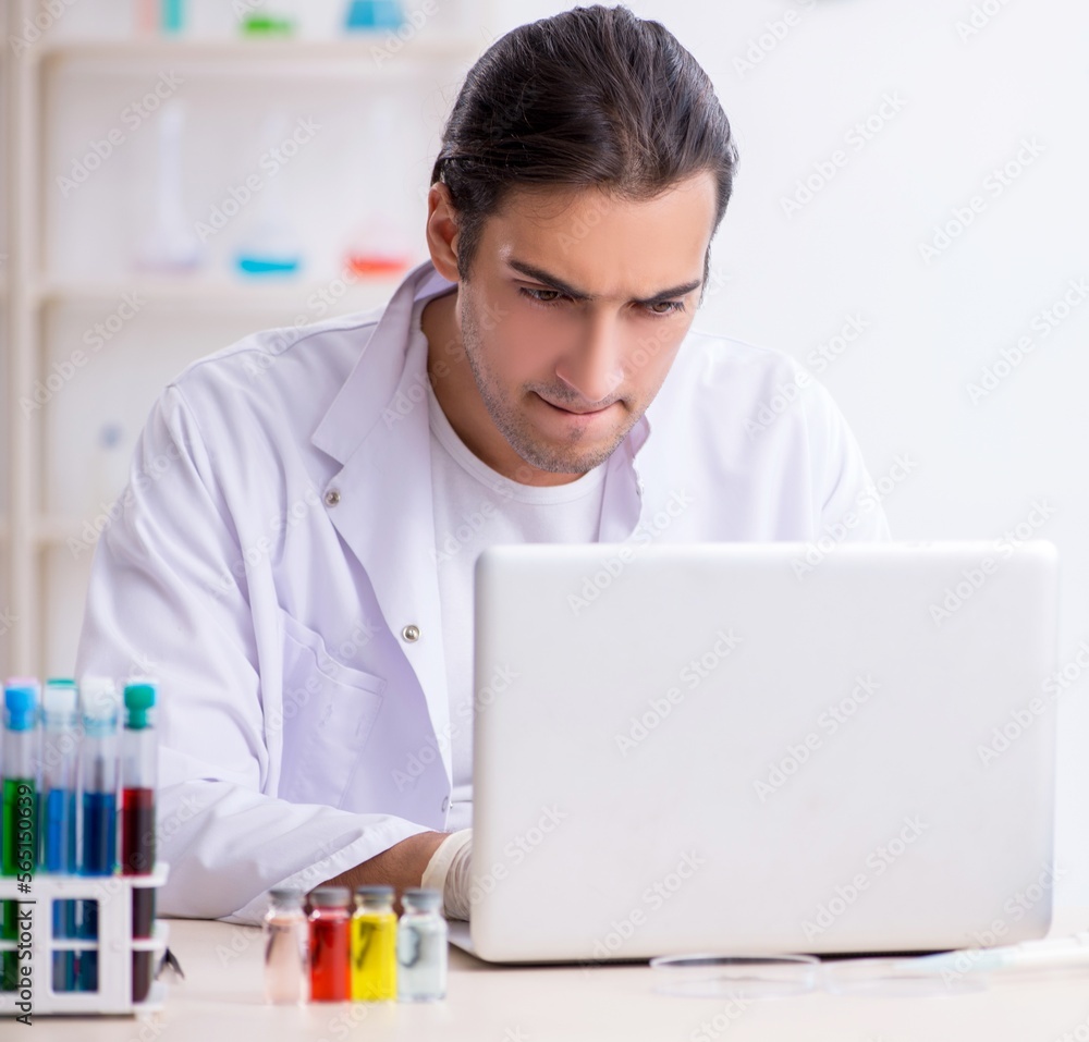 Young male chemist working in the lab Young male chemist working in the lab