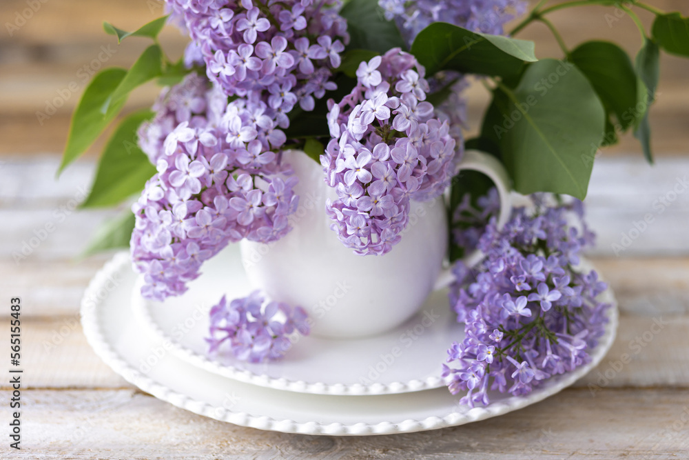Beautiful spring composition with lilac flowers in a white cup for countryside decor. Greeting card for Mother's Day, Women's day, anniversary, birthday Beautiful spring composition with lilac flowers in a white cup for countryside decor. Greeting card for Mother's Day, Women's day, anniversary, birthday