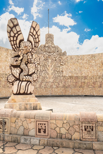 Back of the iconic Monumento a la Patria, located on Paseo de Montejo, showing an eagle devouring a snake on a cactus and a ceiba tree, sacred to the Maya culture. Merida, Yucatan, Mexico. photo