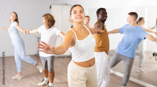 Positive people dancing together slow ballroom dances in pairs in choreography class
