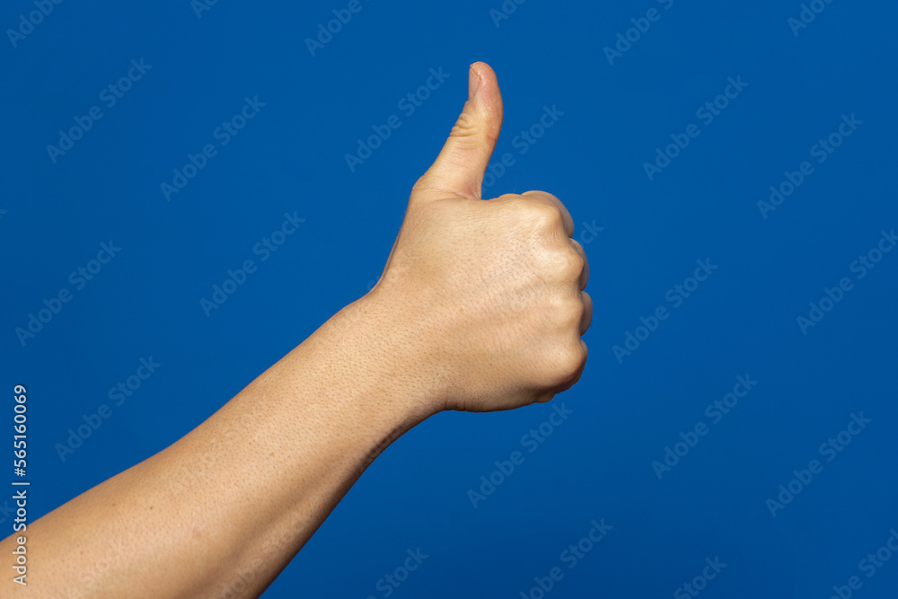 Thumbs up isolated on blue background, with clipping path, concept Admiration, Excellent. Thumbs up isolated on blue background, with clipping path, concept Admiration, Excellent.