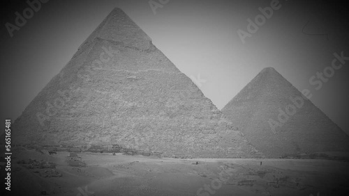 Giza pyramid complex, also called Giza Necropolis, is site on Giza Plateau near Cairo, Egypt. Pyramids of Khufu and Khafre. Video in retro style like an old black and white film photo