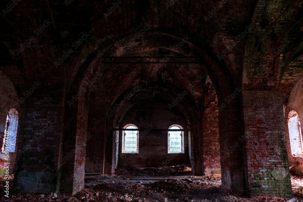 An old ruined temple, a red brick church, inside, windows with iron bars. Architecture.