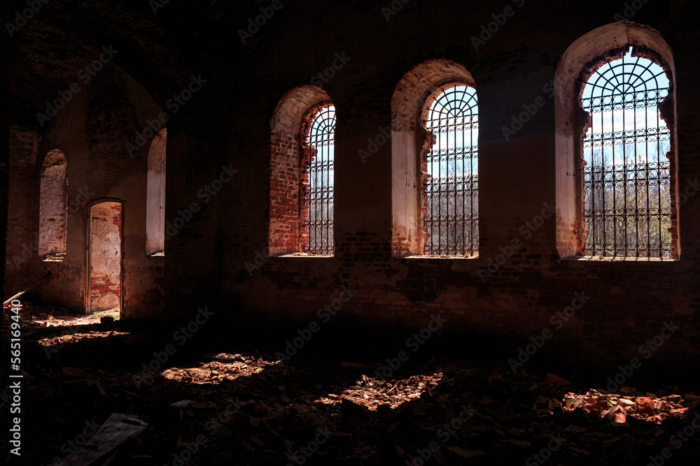 An old ruined temple, a red brick church, inside, windows with iron bars. Architecture, faith, religion.